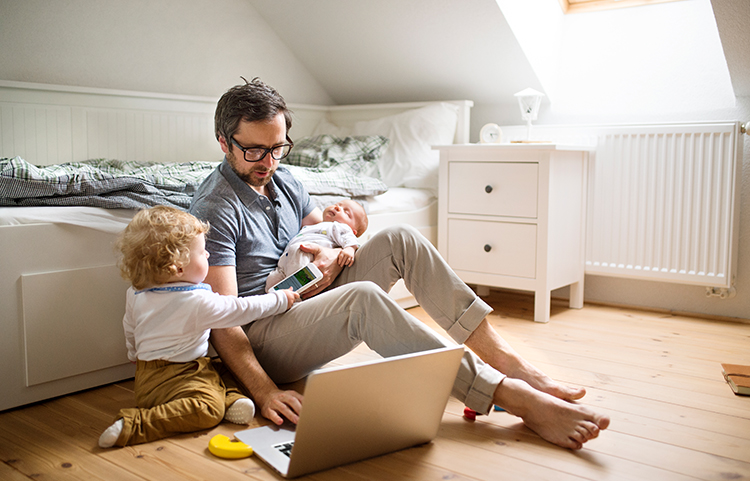 Father and children looking at a laptop